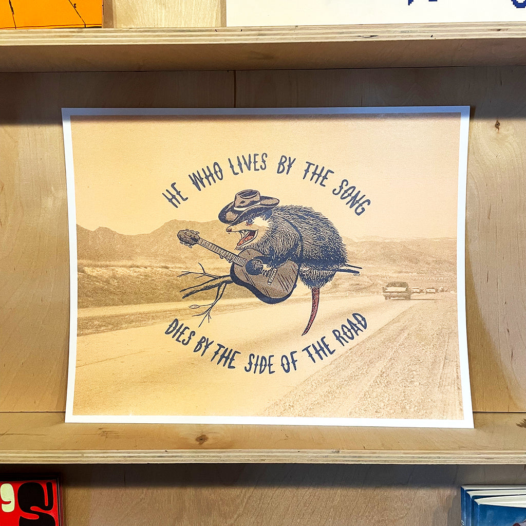 Poster with a stylized illustration of a opossum playing guitar and text on a wooden surface